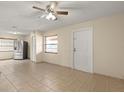 Spacious living area featuring tile floors and neutral wall, seamlessly connected to the kitchen at 704 Michigan Ct # 4, St Cloud, FL 34769