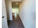 Inviting hallway with stylish, large-format tile flooring leading into the open-concept living area at 8023 Sayings Dr, Winter Garden, FL 34787