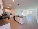 Spacious kitchen featuring stainless steel appliances, white cabinets, and a central island at 8023 Sayings Dr, Winter Garden, FL 34787