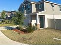 Charming two-story home with a two-car garage, green door, neutral colors and well-maintained landscaping at 804 Timberland Dr, Eagle Lake, FL 33839