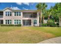 The backyard has a screened lanai, fenced-in lawn, and partial view of surrounding greenery at 8374 Quimby Cir # 8374, Davenport, FL 33896