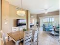 Open-concept living area with dining table and access to balcony at 8774 Worldquest Blvd # 7503, Orlando, FL 32821