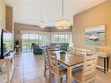Bright living space with tile flooring and access to a screened lanai at 8774 Worldquest Blvd # 7503, Orlando, FL 32821