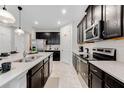 Well-equipped kitchen boasting granite countertops, stainless steel appliances, and ample cabinet space at 8943 Amelia Downs Trl, Kissimmee, FL 34747