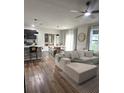 Bright open-concept living room and dining area with wood floors and modern decor at 9016 Pyrus St, Kissimmee, FL 34747