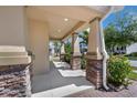 Spacious covered porch with stone-accented columns, offering a welcoming entrance and an elegant outdoor space at 9056 Pinch Shot Dr, Winter Garden, FL 34787