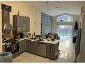 Open-concept kitchen flowing into the dining and living area with a pool view at 1019 Lake Berkley Dr, Kissimmee, FL 34746
