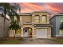 Inviting two-story home with a well-manicured lawn and a charming front porch with beautiful sky backdrop at 1190 Sandestin Way, Orlando, FL 32824
