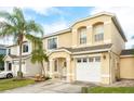 Inviting two-story home with a well-manicured lawn and a charming front porch with an attached two-car garage at 1190 Sandestin Way, Orlando, FL 32824
