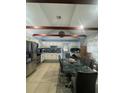 Spacious kitchen featuring stainless steel appliances, granite countertops, and eat-in dining area at 130 Avenue H Se, Winter Haven, FL 33880