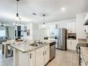Bright open-concept kitchen with granite countertops and stainless steel appliances at 1304 Berry Ln, Davenport, FL 33837