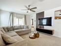 Cozy living room featuring a comfortable sectional sofa and a modern entertainment center at 1304 Berry Ln, Davenport, FL 33837