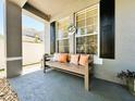 Cozy front porch with a bench and decorative pillows, creating a welcoming entrance to the home at 14963 Braywood Trl, Orlando, FL 32824