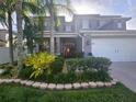 Charming two-story home with well-manicured landscaping and an attached two-car garage at 14963 Braywood Trl, Orlando, FL 32824