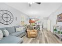 Inviting living room featuring an open-concept design, recessed lighting, and wood floors at 1773 Barton Towne Cir, St Cloud, FL 34769