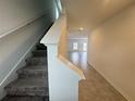 Bright foyer featuring a staircase with carpeted steps and leading to a spacious living area at 1796 Foreman Rd, Eagle Lake, FL 33839
