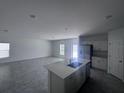Open concept kitchen with stainless steel appliances and a center island that connects to a dining and living area at 1796 Foreman Rd, Eagle Lake, FL 33839