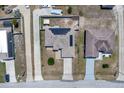 An aerial view reveals a single-Gathering home complete with a two-car driveway and solar panels at 199 Maple Dr, Kissimmee, FL 34759