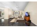Bright living room featuring neutral-colored walls, tile floors, and a comfortable sectional sofa at 2074 King Richards Ct, Orange City, FL 32763
