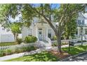Charming two-story home featuring a welcoming front porch, blue door, and a well-maintained picket fence at 212 Ficus St, Celebration, FL 34747