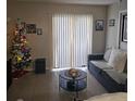 Cozy living room with tile flooring, neutral paint, and ample natural light at 2130 Cascades Blvd # 108, Kissimmee, FL 34741