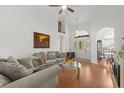 Spacious living room boasts vaulted ceiling, hardwood floors, and large windows for natural light at 2289 Jessica Ln, Kissimmee, FL 34744