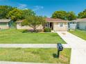 Lovely single-story home with a well-kept front lawn and a classic mailbox near the driveway at 2430 Mill Run Blvd, Kissimmee, FL 34744