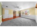 Bright living room with a large window, wood floors, and neutral carpeting at 2430 Mill Run Blvd, Kissimmee, FL 34744