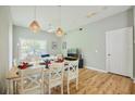 Bright living room and dining area featuring modern decor and wood-look floors at 2611 Gala N Rd # 101, Kissimmee, FL 34746