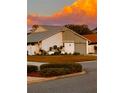 Beautiful single-Gathering home with manicured lawn, flowering plants, and an attached garage at 2615 Autumn Green Dr, Orlando, FL 32822