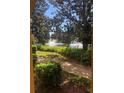 Scenic view of lake with fountains, lush greenery, and trees surrounding the property at 3567 Conroy Rd # 1213, Orlando, FL 32839