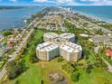 Aerial view of beachfront condo building with pristine landscaping and situated on a golf course at 4 Oceans West Blvd # 301B, Daytona Beach Shores, FL 32118