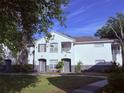 Charming two-story condo with gray doors and a cozy balcony surrounded by lush trees at 4328 S Kirkman Rd # 1, Orlando, FL 32811