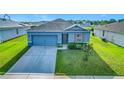 Charming single-Gathering home with a well-maintained lawn, inviting curb appeal, and two car garage at 452 Burnham Cir, Auburndale, FL 33823