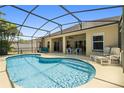 Relaxing screened-in pool area with comfortable lounge chairs and outdoor dining space for entertaining at 5365 Dahlia Reserve Dr, Kissimmee, FL 34758