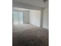 Bright living room featuring neutral walls, plush carpeting, and ample natural light at 567 Caribbean Dr, Davenport, FL 33897