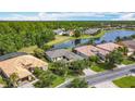 Beautiful aerial shot of homes with lush trees, serene water views and well-manicured lawns at 567 Villa Park Rd, Kissimmee, FL 34759