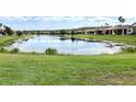 Picturesque lake view surrounded by mature trees and well-maintained lawns, creating a peaceful setting at 817 Grand Canal Dr, Kissimmee, FL 34759