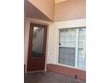 Inviting front entryway features a decorative glass door and a sidelight window with white trim at 8369 Riverdale Ln # 1, Davenport, FL 33896