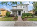 Beautiful two-story home featuring manicured landscaping and a welcoming front porch at 14314 Pleach St, Winter Garden, FL 34787
