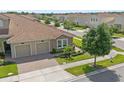 Well-maintained home with a two-car garage, lush landscaping, and a tile roof at 1000 Blackwolf Run Rd, Davenport, FL 33896
