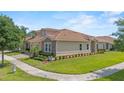 Beautifully landscaped home with a tile roof, well-maintained lawn, and a two-car garage at 1000 Blackwolf Run Rd, Davenport, FL 33896