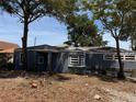 Charming single-story home with blue exterior, stone accents, and mature trees at 115 N 10Th St, Haines City, FL 33844