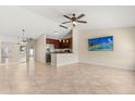 Spacious living room featuring a dining area and a modern kitchen with stainless steel appliances at 1208 Roma Ct, Orlando, FL 32825