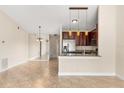 Open-concept living area with tile floors, and adjacent kitchen and dining spaces at 1208 Roma Ct, Orlando, FL 32825