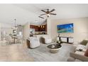 Cozy living room featuring a flat-screen TV, a dining area, and a modern kitchen with stainless steel appliances at 1208 Roma Ct, Orlando, FL 32825