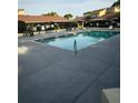 Community swimming pool surrounded by tables and chairs; perfect for relaxing and enjoying the outdoors at 135 Pine Island Cir, Kissimmee, FL 34743