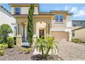 Charming two-story home boasts a well-manicured lawn, a welcoming porch, and an attached two-car garage with a paver driveway at 1817 Caribbean View Ter, Kissimmee, FL 34747