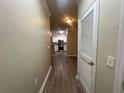 Hallway leading to the kitchen showcasing wood-look floors and natural light at 19935 Villa Isle Dr # 107, Orlando, FL 32821