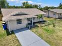 Charming single story home featuring a well-maintained lawn, fresh paint, and a decorative front door at 2317 10Th St, St Cloud, FL 34769